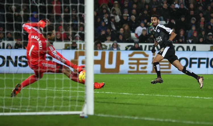 SWANSEA, WALES - DECEMBER 05: Riyad Mahrez of Leicester City scores his team's third and hat trick goal at Swansea. (Photo by Ben Hoskins/Getty Images)