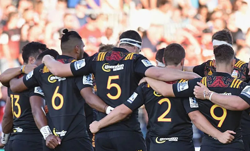 CHRISTCHURCH, NEW ZEALAND - FEBRUARY 27: The Chiefs team during a moment's silence before kickoff as a mark of respect for the Fiji cyclone victims, the 185 lives lost in the Christchurch earthquake five years ago, and Crusaders board member Nick Patterson, who died earlier in February, prior to the round one Super Rugby match between the Crusaders and the Chiefs at AMI Stadium on February 27, 2016 in Christchurch, New Zealand. (Photo by Kai Schwoerer/Getty Images)