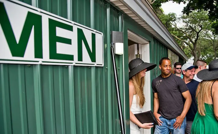 Men watch as women walk out of the men's toilet to skip the longer queue for The Ladies on Belmont Stakes Day 2016, in Elmont, New York. (Photo: Scott Serio/Eclipse Sportswire/Getty Images)