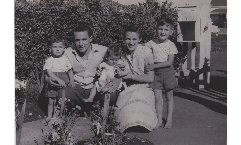 A black and white photo of a family of two adults and three children.