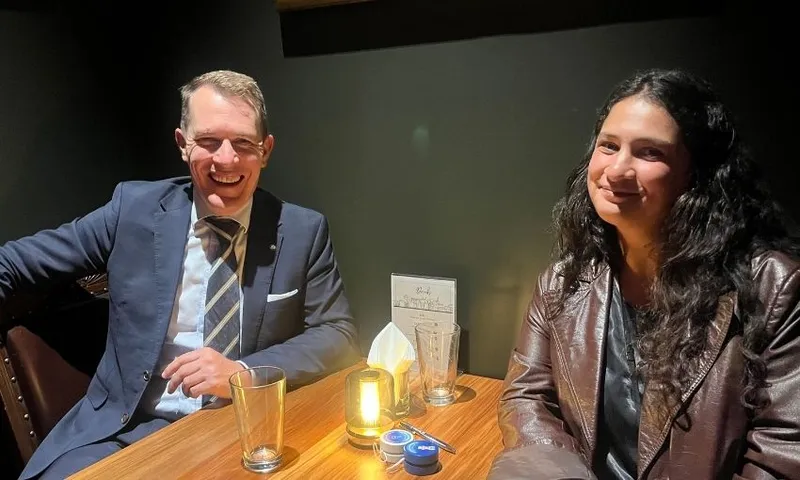 Hamish Campbell and the author sit and smile from a pub table.