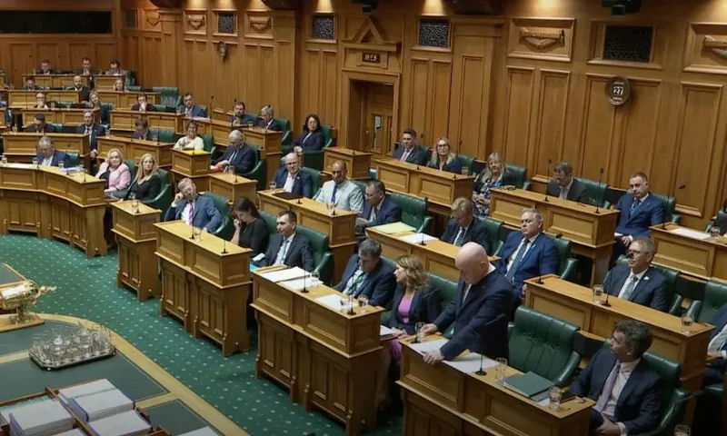 A wide view of the House, showing Christopher Luxon standing at his bench.