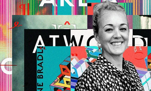 A black and white photo of Gina Butson who is a young woman. She is smiling and wearing a spotted top. Behind her is a collage of book covers.