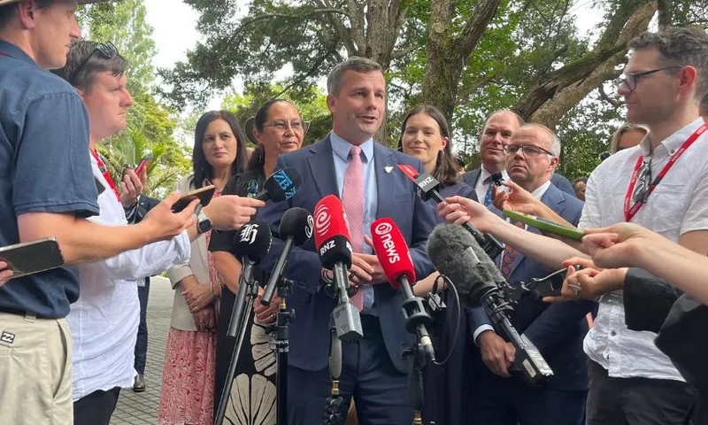 David Seymour, flanked by Act Party MPs, speaks to a media scrum on the treaty grounds.