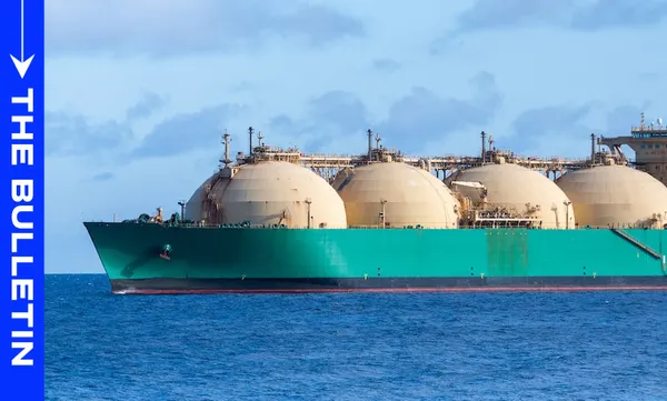 A large green LNG tanker with spherical storage tanks sails on calm blue water under a partly cloudy sky; “The Bulletin” is written vertically on a blue bar on the left side.