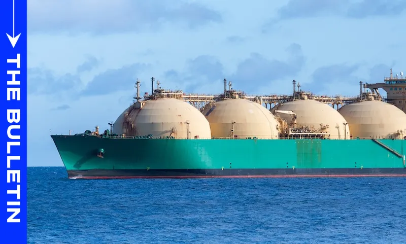 A large green LNG tanker with spherical storage tanks sails on calm blue water under a partly cloudy sky; “The Bulletin” is written vertically on a blue bar on the left side.