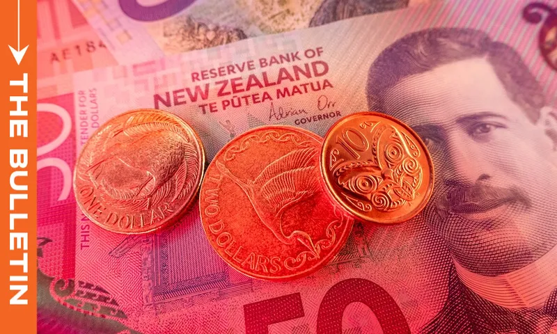 New Zealand coins and a fifty-dollar banknote featuring a portrait, with “The Bulletin” text on a vertical orange bar to the left. The scene highlights New Zealand currency in close-up detail.
