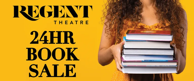 A promotional banner for the 24 hour book sale in Dunedin which shows a photo of a young woman with long hair holding a stack of books. Her head is cropped out of the image.