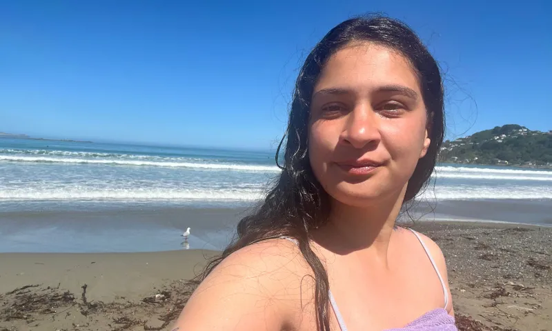 The author stands in front of Lyall Bay in a towel.