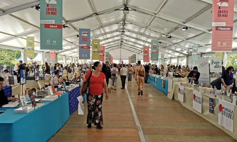 A photo of a large marquee with a wide aisle down the middle and rows and rows of stallholders on either side.