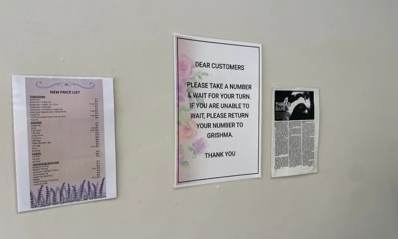 Three laminated pieces of paper on a beige wall
