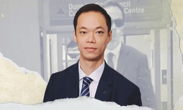 Dunedin City Councillor Benedict Ong wears a suit and looks directly at the camera
