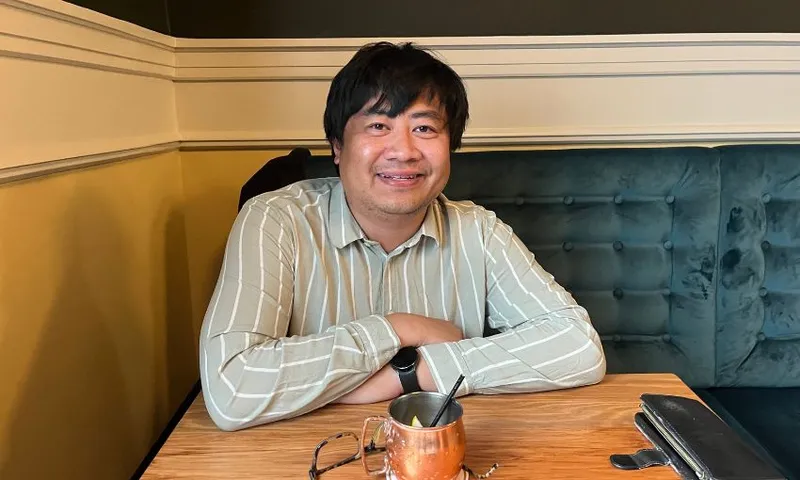 Francisco Hernandez smiles from a pub table.