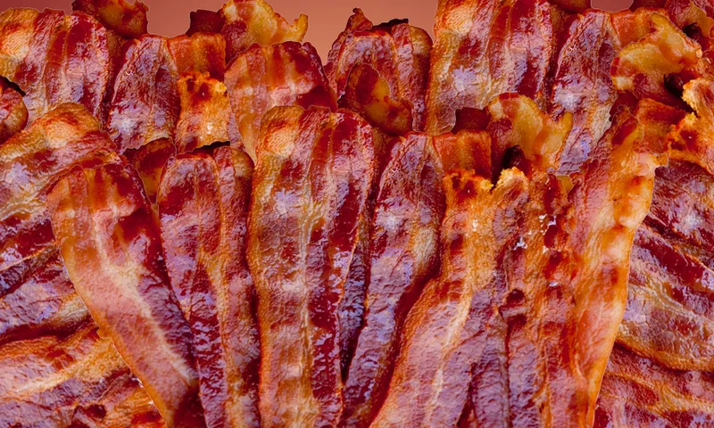 a photo of kinda crispy rashers tof dark red bacon