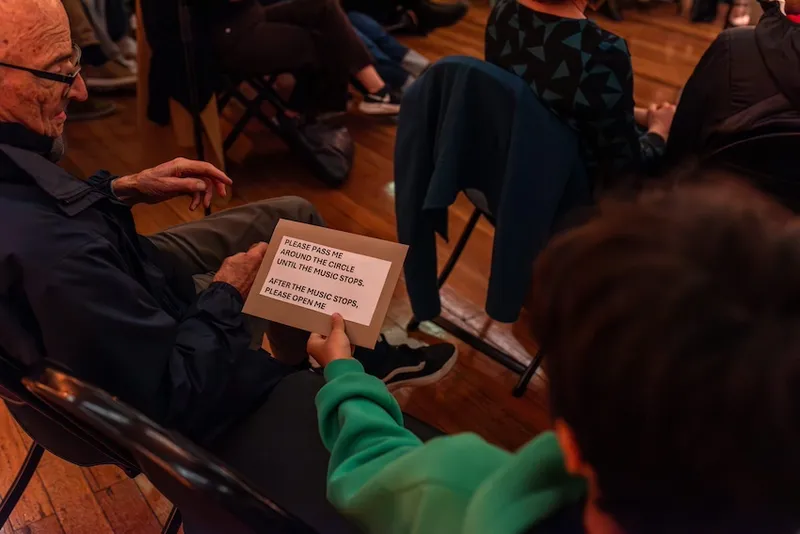 A hand holds an envelope with a message written on the outside