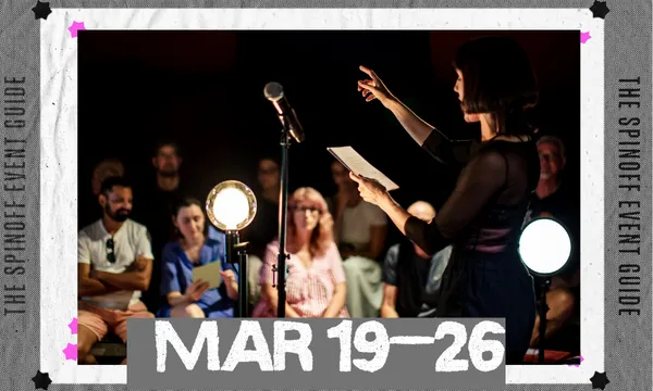 A photo of a woman performing, and holding a piece of paper, in front of a captivated audience.