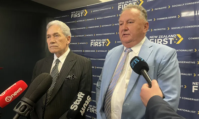 Winston Peters and Shane Jones speak to media in front of a NZ First banner.