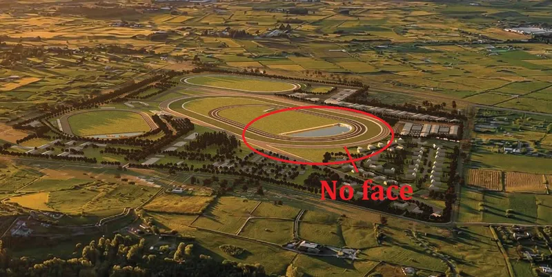 Aerial view of a large, green racetrack complex with multiple tracks and facilities. A red circle and arrow highlight a pond in the center, with the text “No face” written in red. Surrounding farmland is visible.