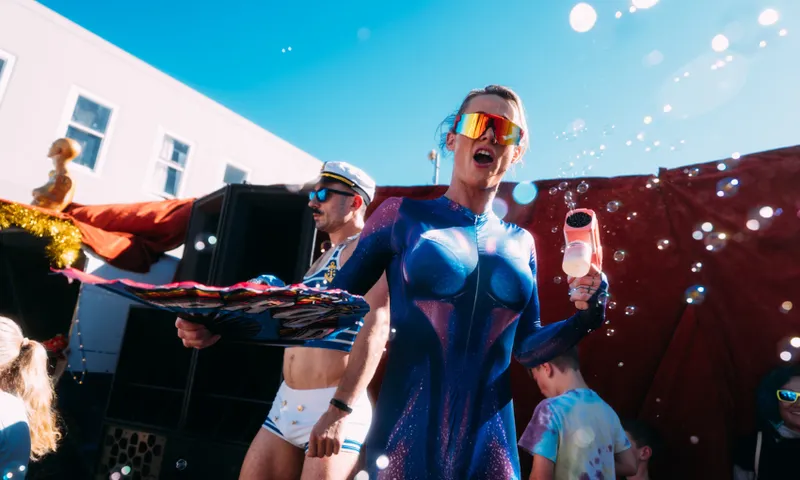 A street performer shouts into the camera at Cuba Dupa in Wellington. The weather is fine and there are bubbles around.