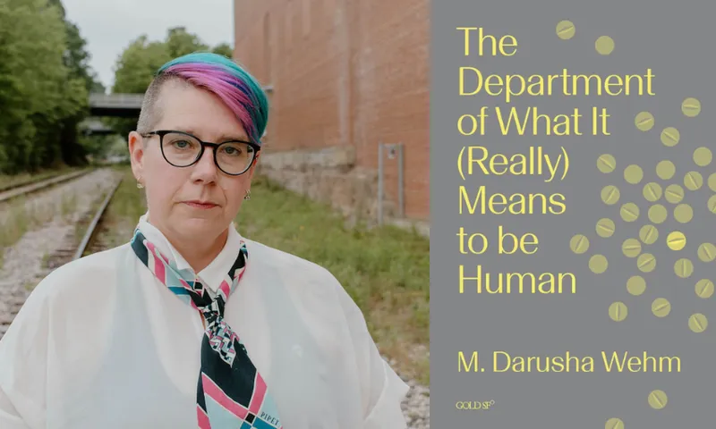 A photo of author Darusha Wehm who has short colourful hair, glasses and is wearing a shirt and scarf-tie. Beside her is the cover of her book which is grey with yellow lettering filling the space.