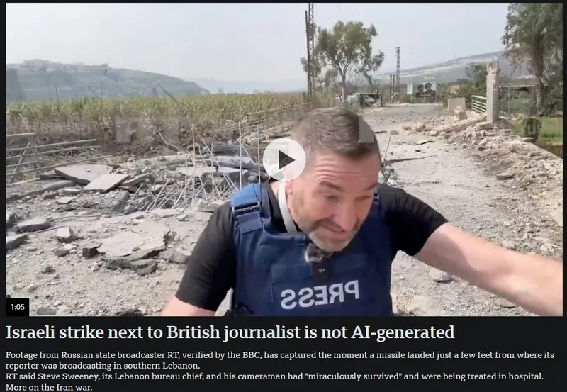 A journalist wearing a blue "PRESS" vest stands in front of debris and a damaged road, with fields and a broken fence visible in the background, after a missile strike in southern Lebanon.
