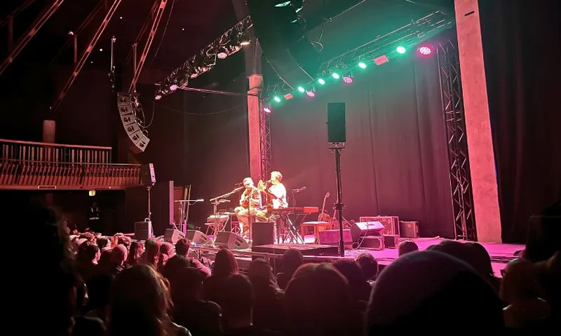 A semi-blurry photo of Bret Mckenzie and Jemaine Clement playing guitars onstage at Wellington's Meow Nui.