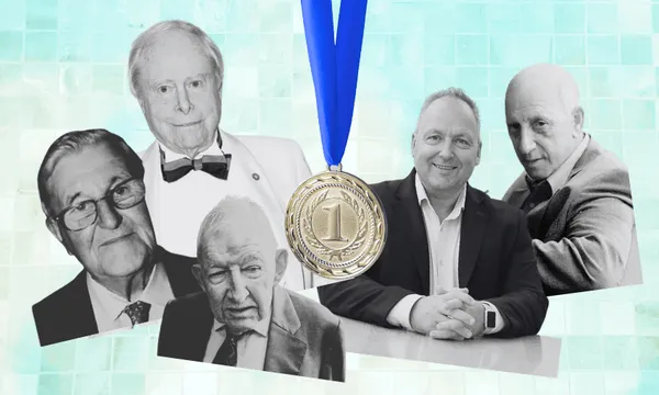 A gold medal with a blue ribbon is centered between five older men in suits, shown in black-and-white, against a blue mosaic background.