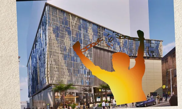 A modern, glass-fronted building with people walking outside. In the foreground, an orange silhouette of a person raises broken chains above their head in a gesture of triumph.