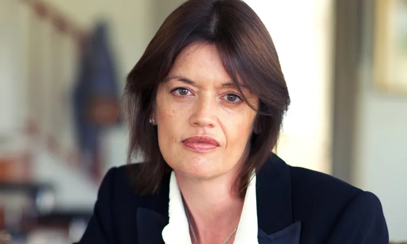 A photo of Charlotte Grimshaw who has short dark hair, is wearing a white shirt and black blazer.