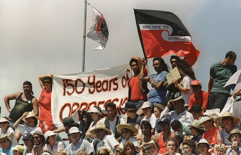 Maori protesters hold banners and streamers during