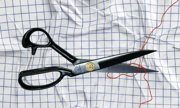 Scissors and thread on graph paper