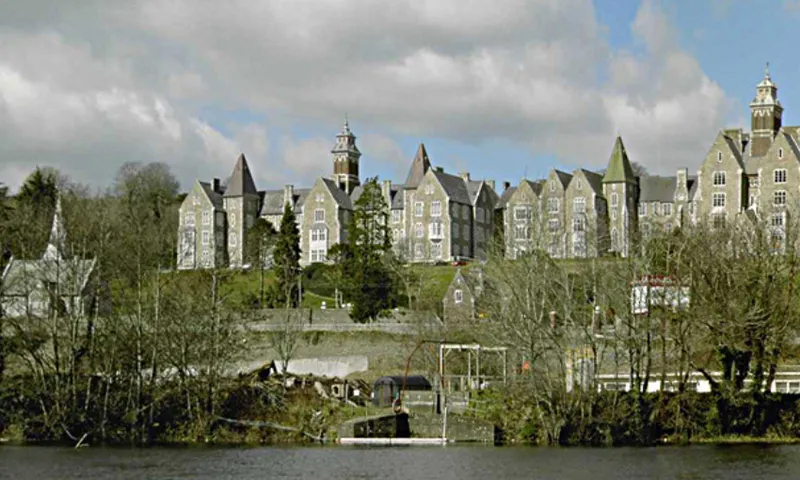 A photo of an abandoned Mental Asylum in Cork, Ireland. The buildings are grey and gothic.