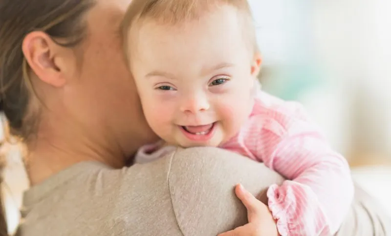 A mother holding a baby girl with Down Syndrome. Photo: JGI/Tom Grill