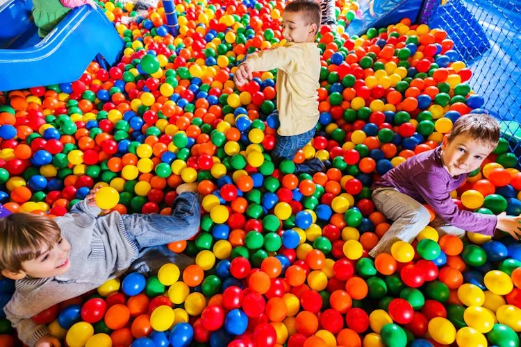 Cute little boys playing in the ball pool.