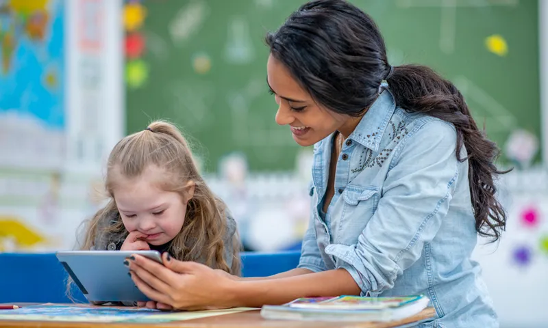 Teaching elementary school girl with a tablet