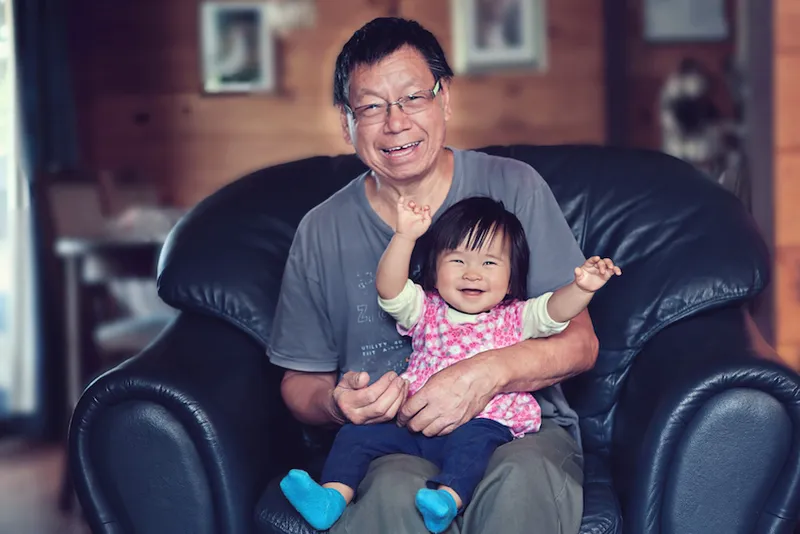 Happy baby girl and grandfather