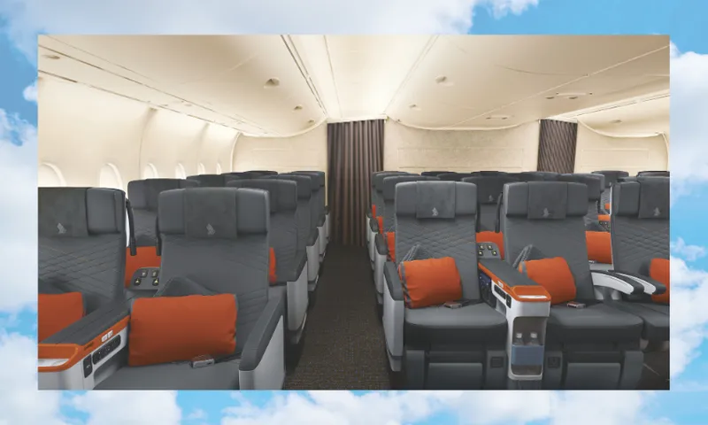 Interior of an airplane showing rows of premium economy seats. Each seat is equipped with a monitor, pillow, and orange accents. The cabin is well-lit, and the backdrop is a cloud-filled blue sky.