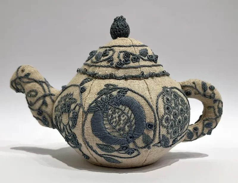 a 3D tea pot made from embroidery and fabric