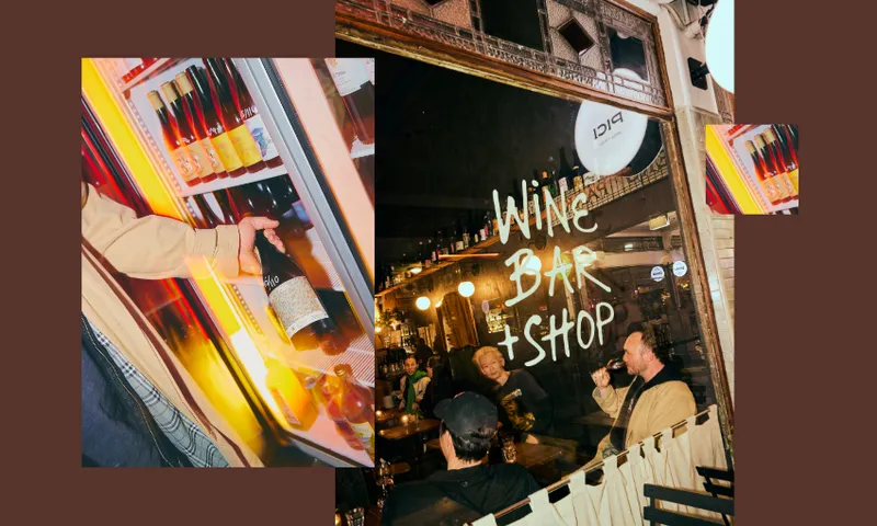 A man drinking wine in a bar.