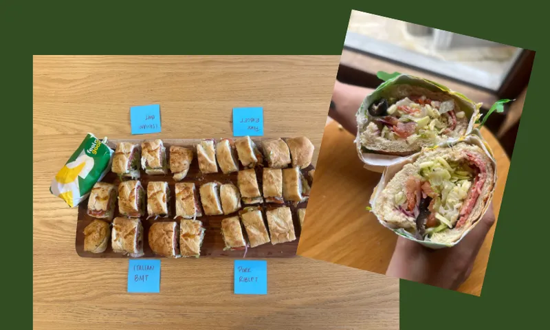 A wooden table displays three types of sliced sandwiches labeled "ITALIAN BMT," "ROAST BEEF," and "THE MONSTER." An inset photo shows a close-up of a hand holding a cross-section of a loaded sandwich.