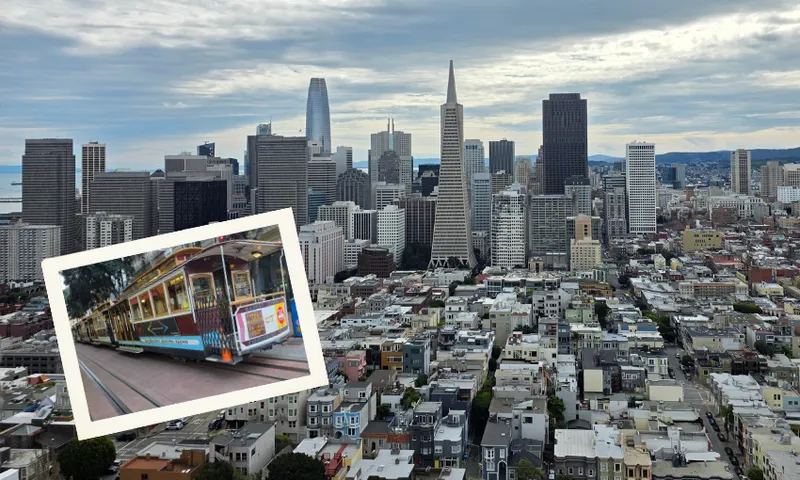 Aerial view of downtown San Francisco with skyscrapers under a cloudy sky; an inset photo shows a classic San Francisco cable car on a street.