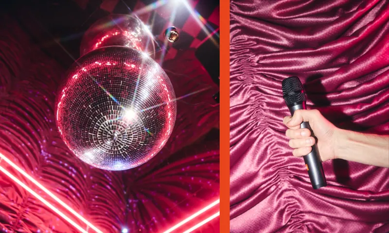 A sparkling disco ball hangs above a red-lit, textured wall on the left, while on the right, a person’s hand holds a black microphone against a backdrop of ruched pink fabric.