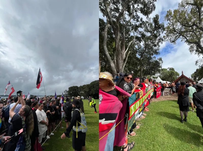 Two crowds stand behind cordons at an outdoor event, some waving flags. One side shows a cloudy sky, the other side is sunny with large trees and people wrapped in red blankets. Both groups face toward the event area.