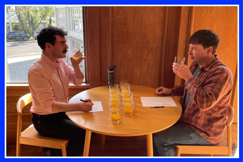 Robbie Nicol and Hayden Donnell drinking orange juice