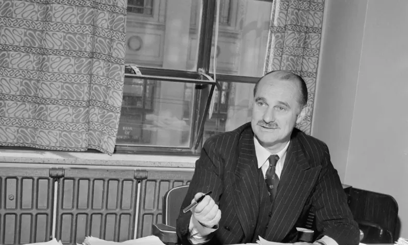 A black and white photo of Bill Sutch at a desk.