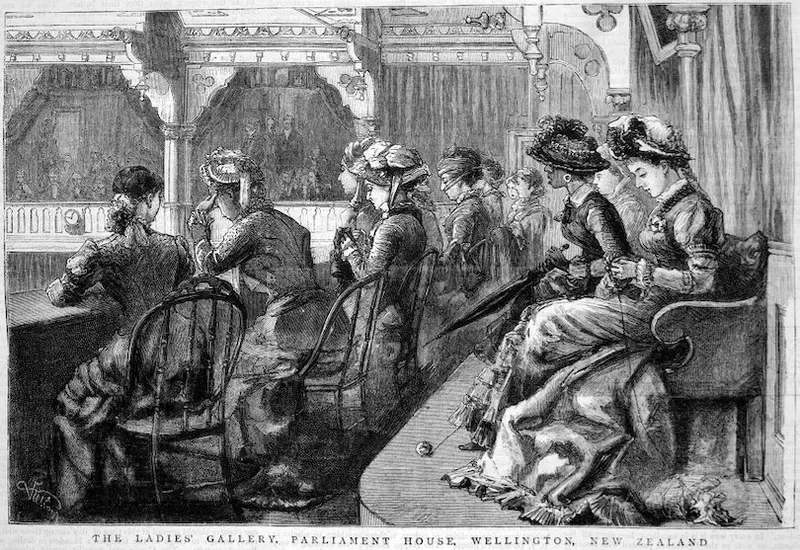 Victorian-era women in dresses and hats sit in the Ladies’ Gallery, Parliament House, Wellington, New Zealand, watching proceedings from ornate balcony seats.