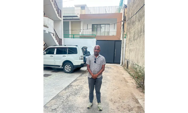 A photo of Brannavan Gnanalingam standing in a street in Sri Lanka.