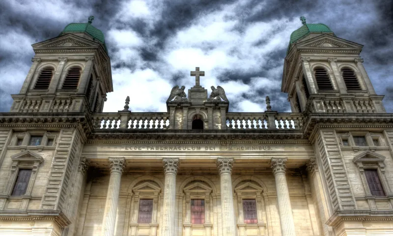 A photo of the Christchurch Basilica with dramatic sky, cloud backlit by the moon.