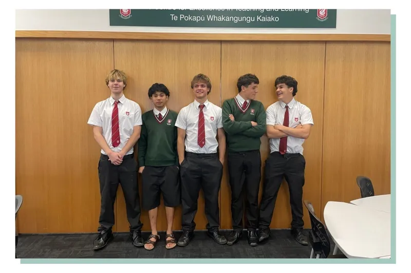 The boys stand in a line in front of the doors to the teachers' loung