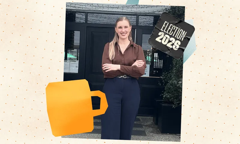 A blonde white woman stands smiling with her arms crossed in front of Urban Soul cafe in Karaka, Auckland.
